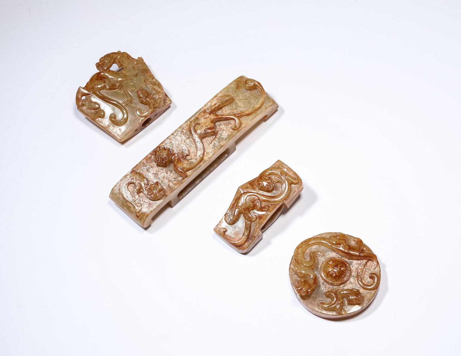 A GROUP OF JADE SWORD FITTINGS: A GROUP OF JADE SWORD FITTINGS Dimensions: Length: 10.9 cm (4.29 in) x Width: 2.8 cm (1.10 in) x Height: 2.1 cm (0.83 in).Width: 5.0 cm (1.97 in). All measurements are approximate.