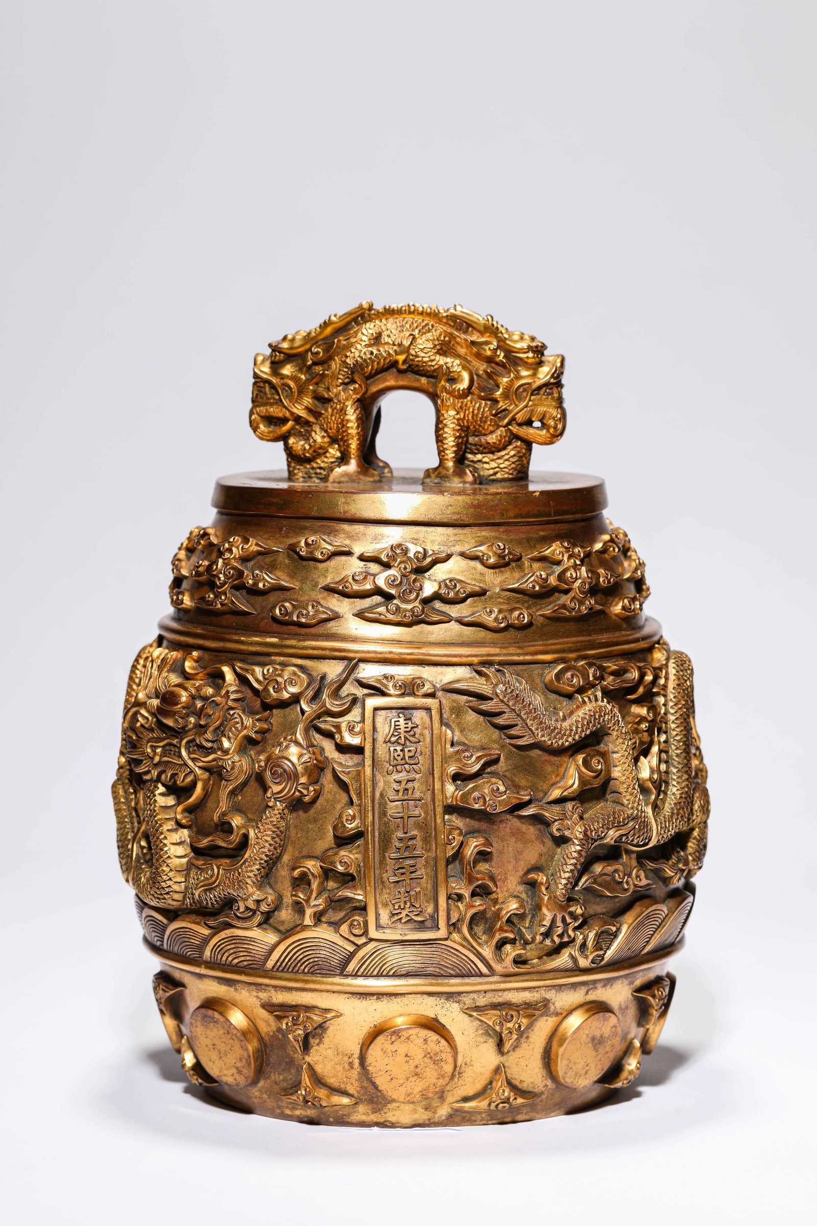 A GILT-BRONZE 'FLOOD DRAGON-FORM FINIAL' BELL: A GILT-BRONZE 'FLOOD DRAGON-FORM FINIAL' BELL Dimensions: Weight: 15.2kg. Length: 20.0 cm (7.87 in) x Width: 19.6 cm (7.72 in) x Height: 27.0 cm (10.63 in). All measurements are approximate.