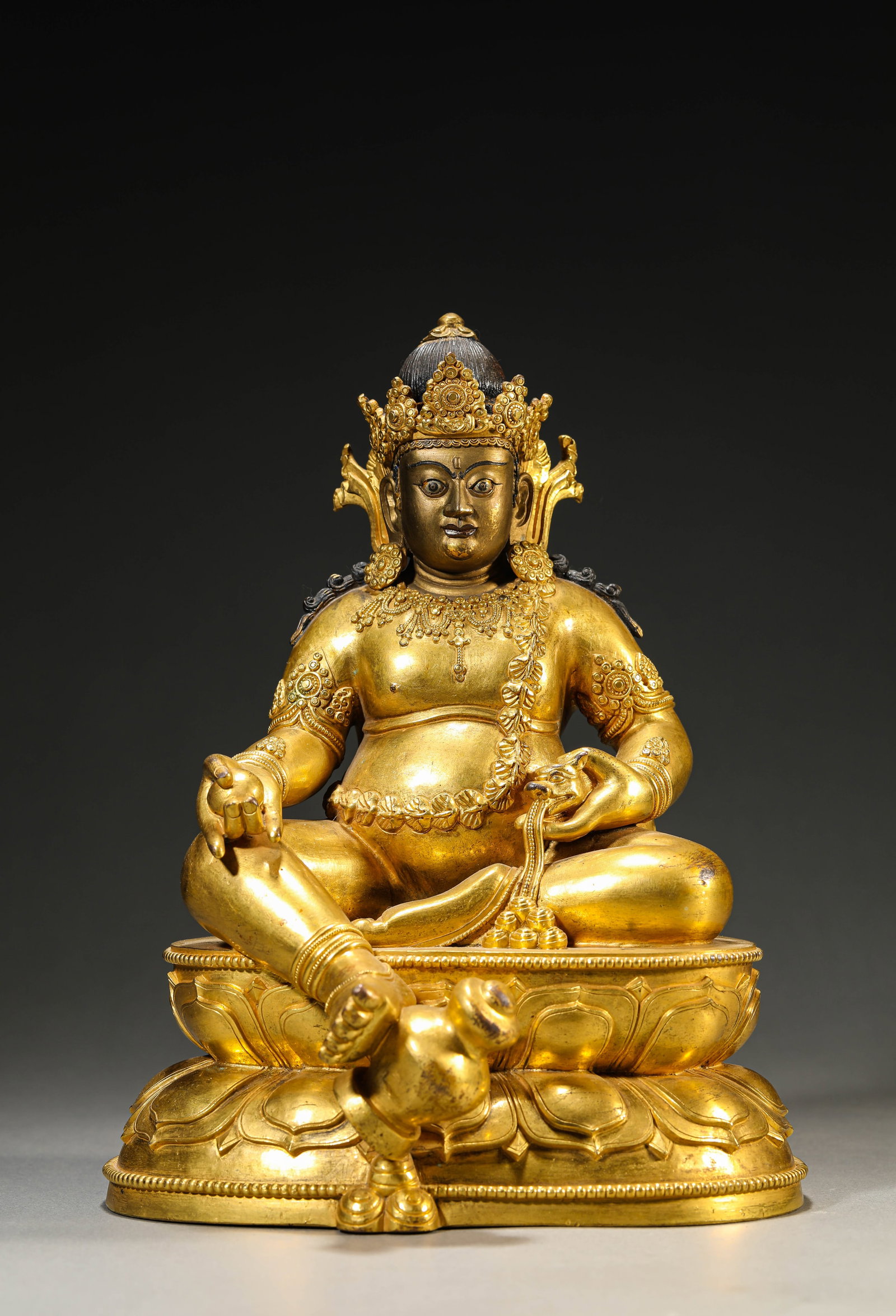 A GILT-BRONZE FIGURE OF YELLOW JAMBHALA (1 of 7)