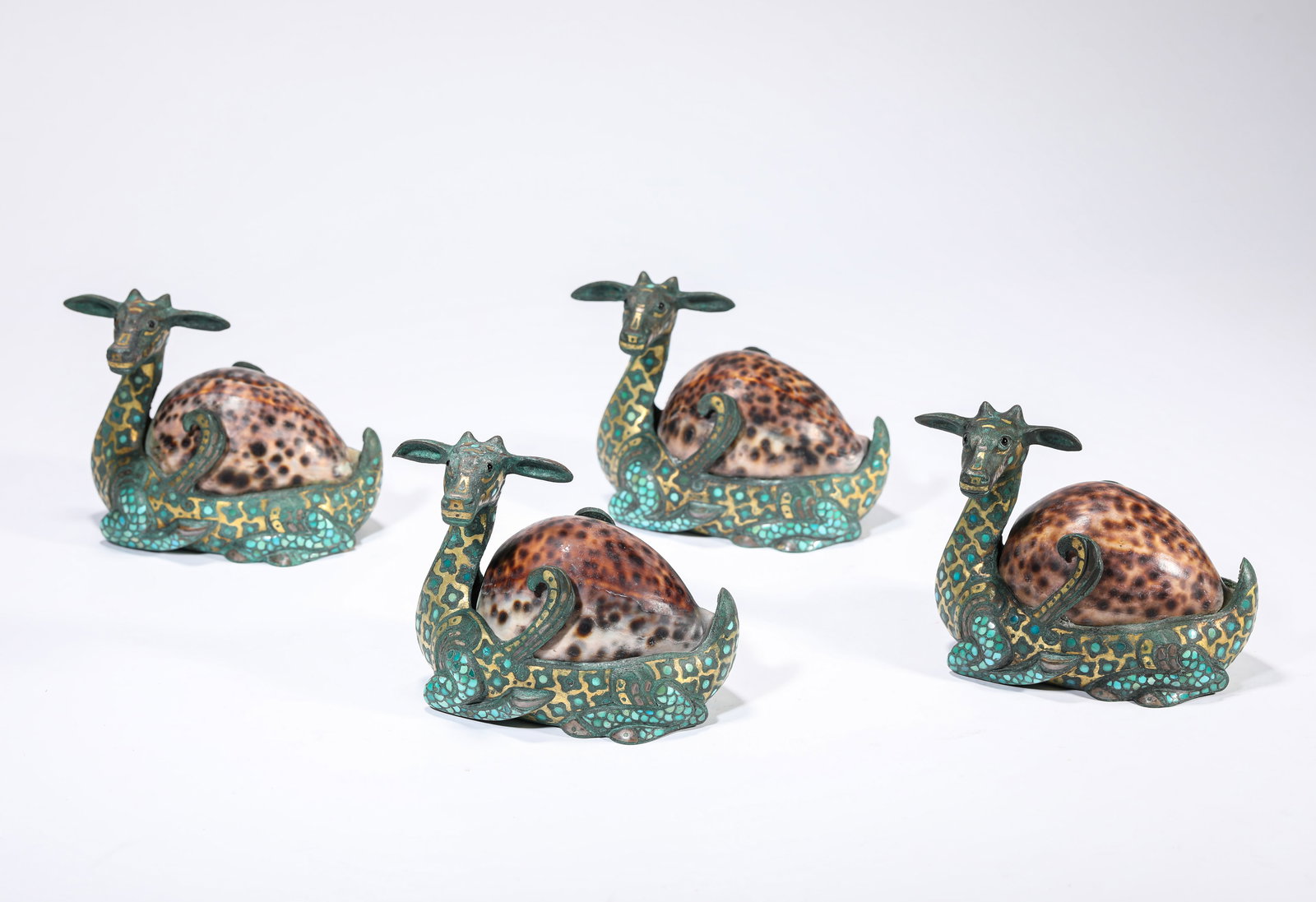 A GOLD AND TURQUOISE-INLAID BRONZE 'DEER-FORM' PAPERWEIGHT: A GOLD AND TURQUOISE-INLAID BRONZE 'DEER-FORM' PAPERWEIGHT Dimensions: Weight: 2455g. Length: 12.6 cm (4.96 in) x Width: 7.5 cm (2.95 in) x Height: 9.7 cm (3.82 in). All measurements are approximate.