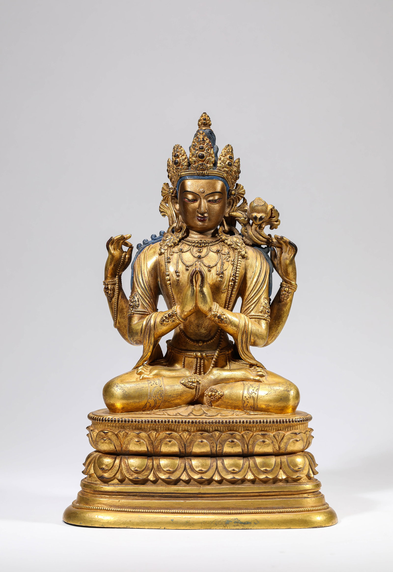 A GILT-BRONZE FIGURE OF FOUR-ARMED AVALOKITESHVARA: A GILT-BRONZE FIGURE OF FOUR-ARMED AVALOKITESHVARA Dimensions: Weight: 3839g. Length: 19.3 cm (7.60 in) x Width: 12.4 cm (4.88 in) x Height: 29.0 cm (11.42 in). All measurements are approximate.
