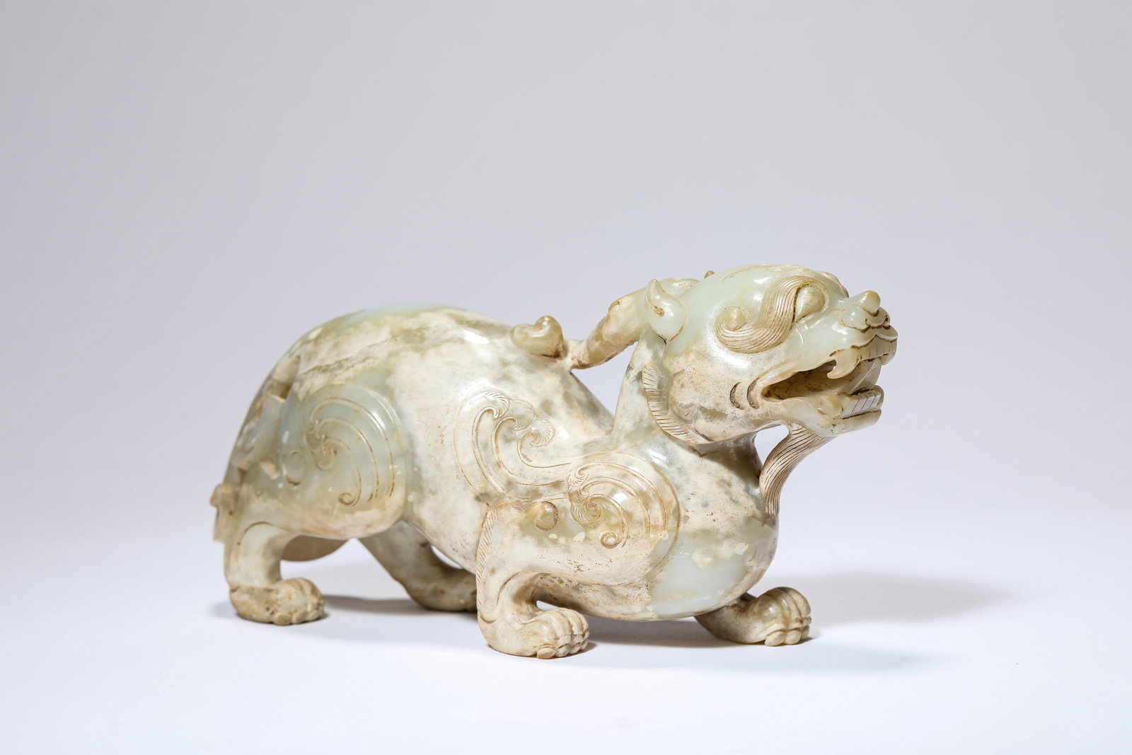 A JADE 'AUSPICIOUS BEAST': A JADE 'AUSPICIOUS BEAST' Dimensions: Length: 15.3 cm (6.02 in) x Width: 5.0 cm (1.97 in) x Height: 8.5 cm (3.35 in). All measurements are approximate.