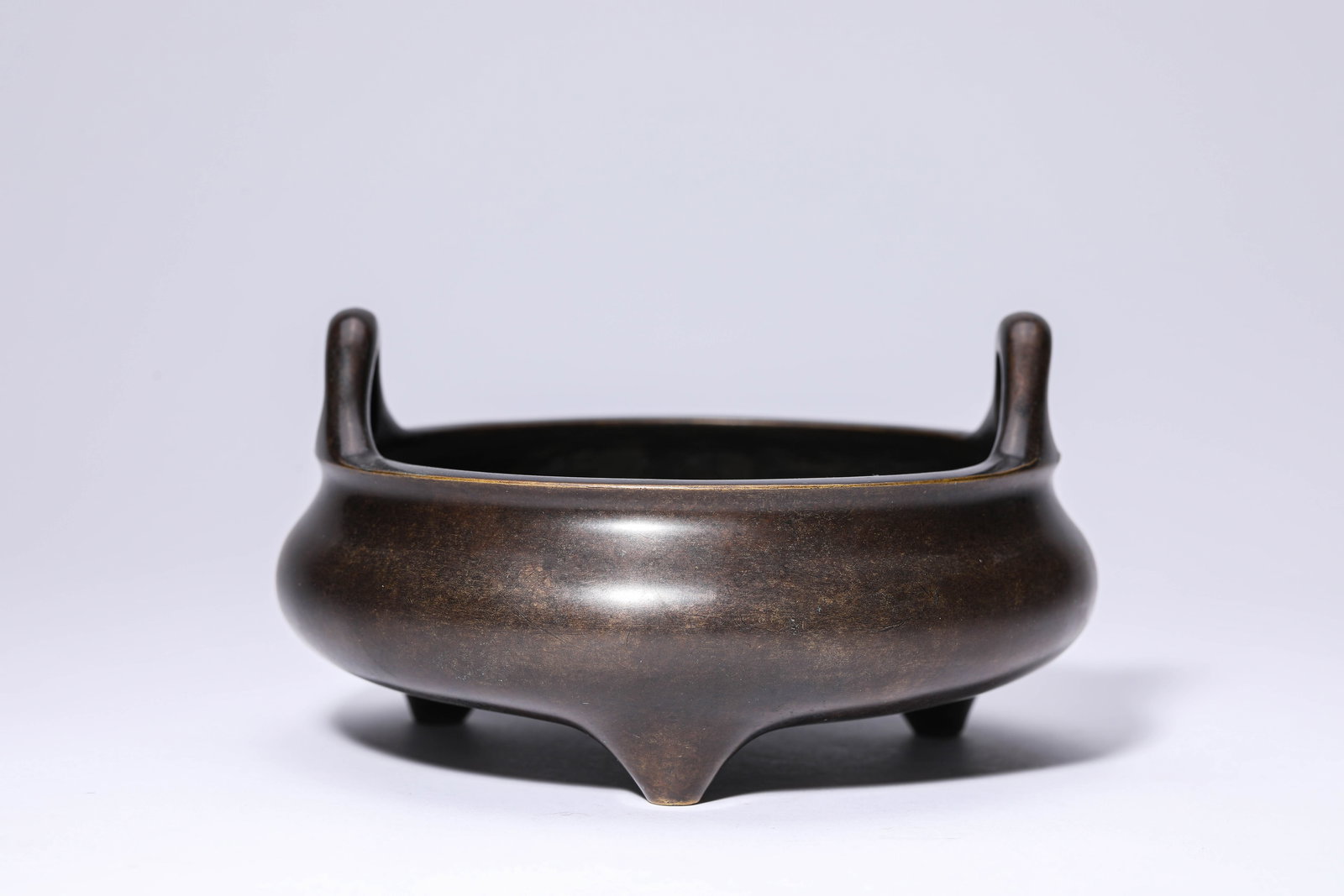 A BRONZE 'UPRIGHT-HANDLED' CENSER (1 of 5)