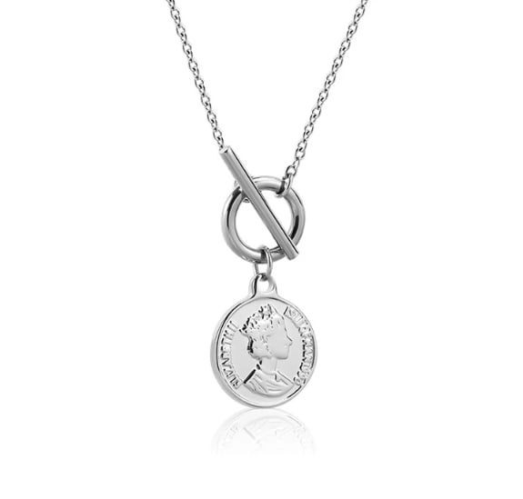 PENDANT NECKLACE: PENDANT NECKLACE Description: A polished silver-tone pendant necklace featuring a linked chain, a central round ring and bar toggle element, and a dangling medallion engraved with a classical female