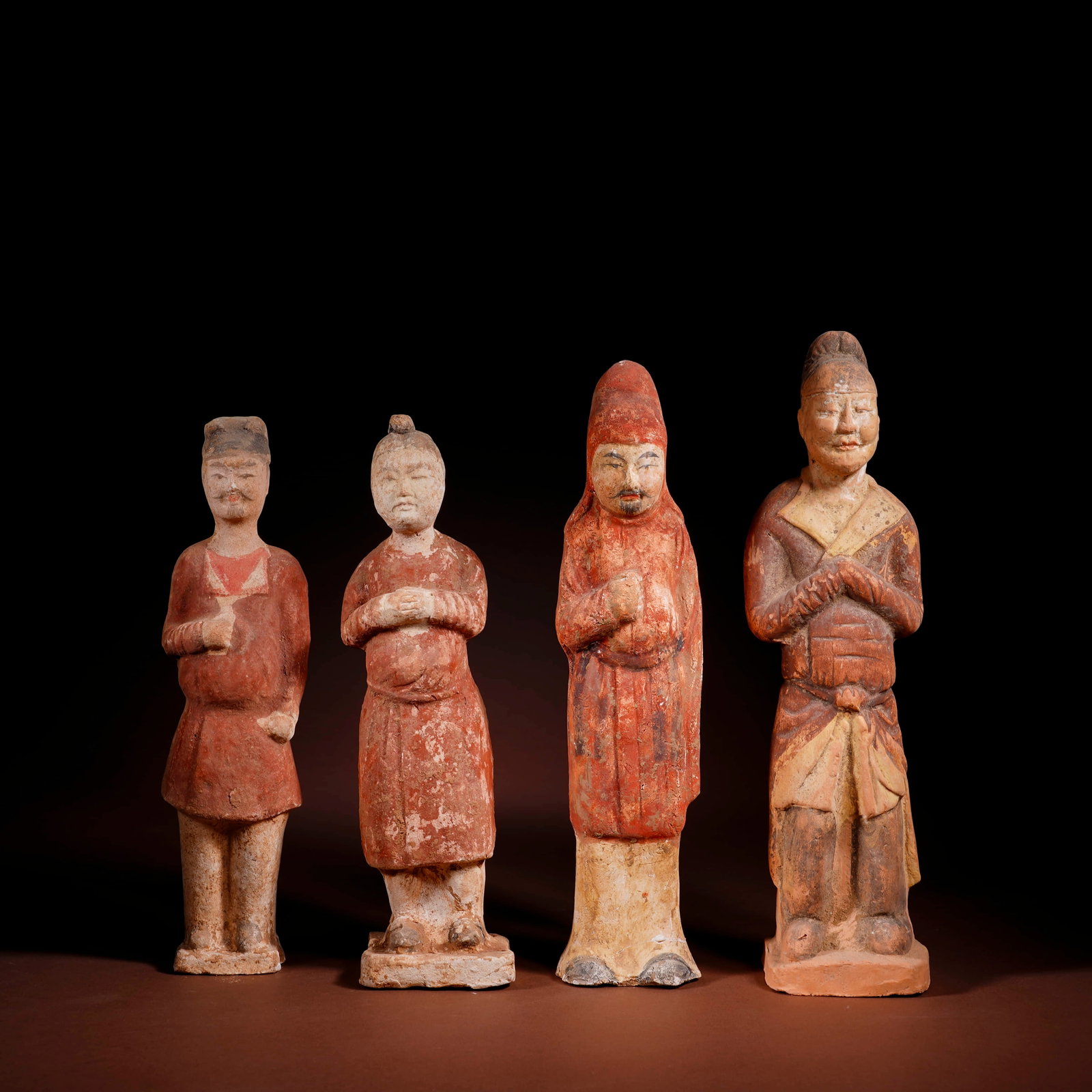 A GROUP OF 4 PAINTED POTTERY FIGURINES (1 of 3)