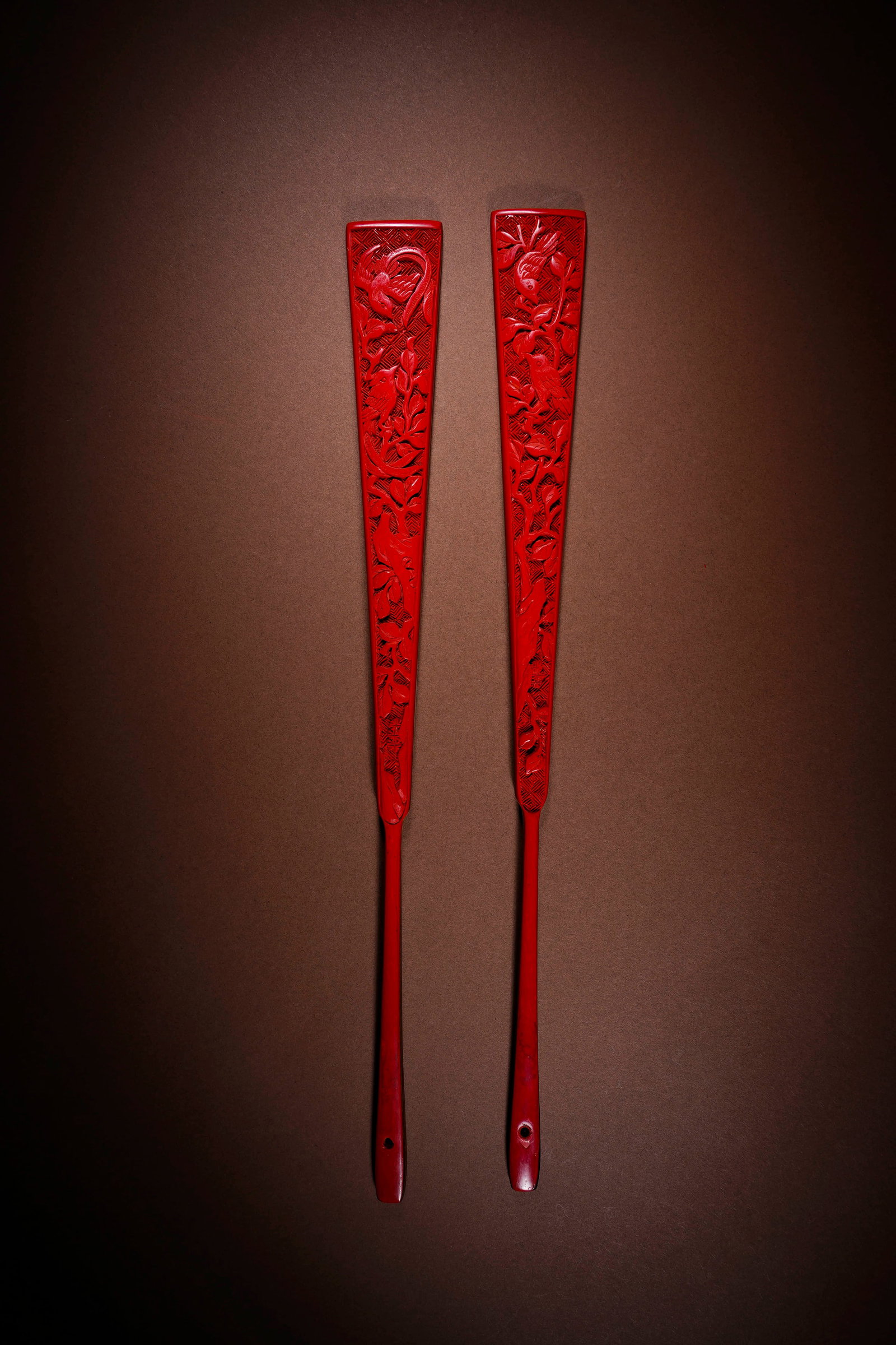 A SET OF CARVED CINNABAR LACQUER 'MAGPIE ON PLUM BRANCH' FAN RIBS (1 of 3)