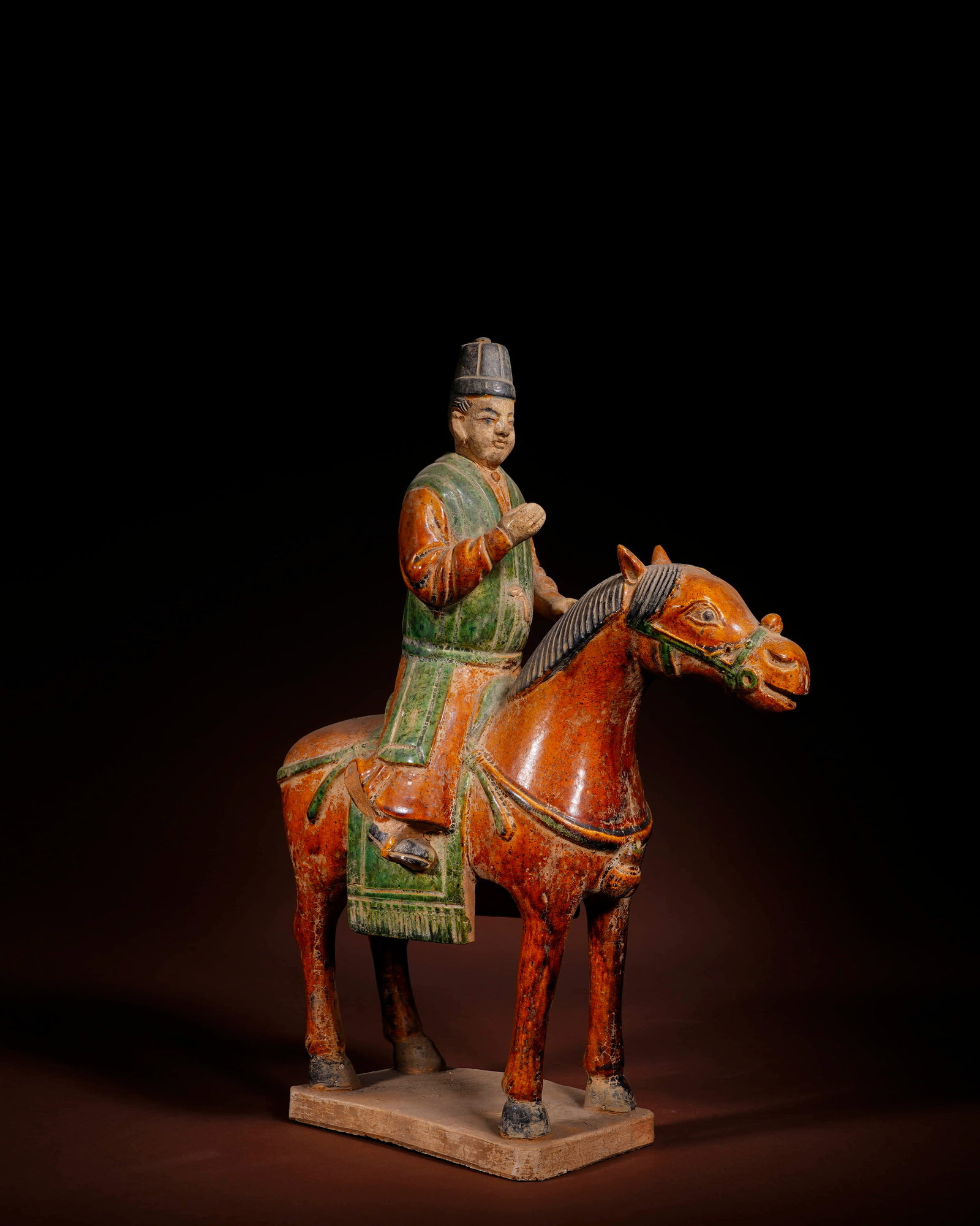 A RED SANCAI-GLAZED POTTERY 'OFFICIAL WITH BLACK HAT' HORSE AND FIGURE (1 of 4)