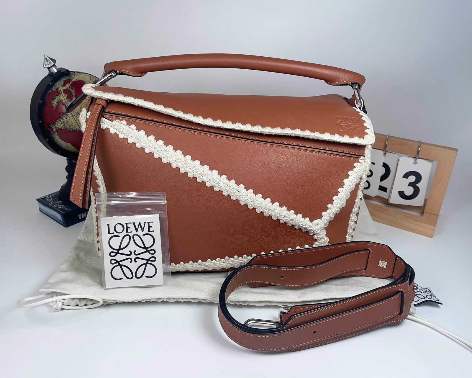 LOEWE PUZZLE GEOMETRIC PANELLED HANDBAG: LOEWE PUZZLE GEOMETRIC PANELLED HANDBAG LOEWE Puzzle Top-Handle Bag. Crafted from supple calfskin with the house's signature geometric panel construction and hand-braided trim. The compartmentalized
