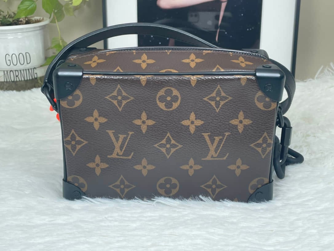 LOUIS VUITTON MINI SOFT TRUNK MONOGRAM BAG: LOUIS VUITTON MINI SOFT TRUNK MONOGRAM BAG LOUIS VUITTON, Mini Soft Trunk. A brown Monogram canvas shoulder bag with black-tone metal fittings and chain detail. Designed for unisex use. Presented in