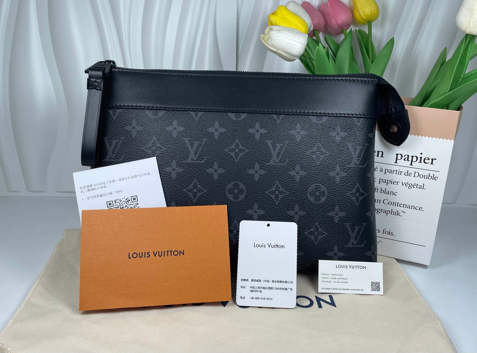 LOUIS VUITTON POCHETTE VOYAGE SOUPLE: LOUIS VUITTON POCHETTE VOYAGE SOUPLE LOUIS VUITTON, Pochette Voyage Souple. A microchip-era pouch crafted from black and grey Monogram canvas with smooth leather trim. Designed for use as a clutch or