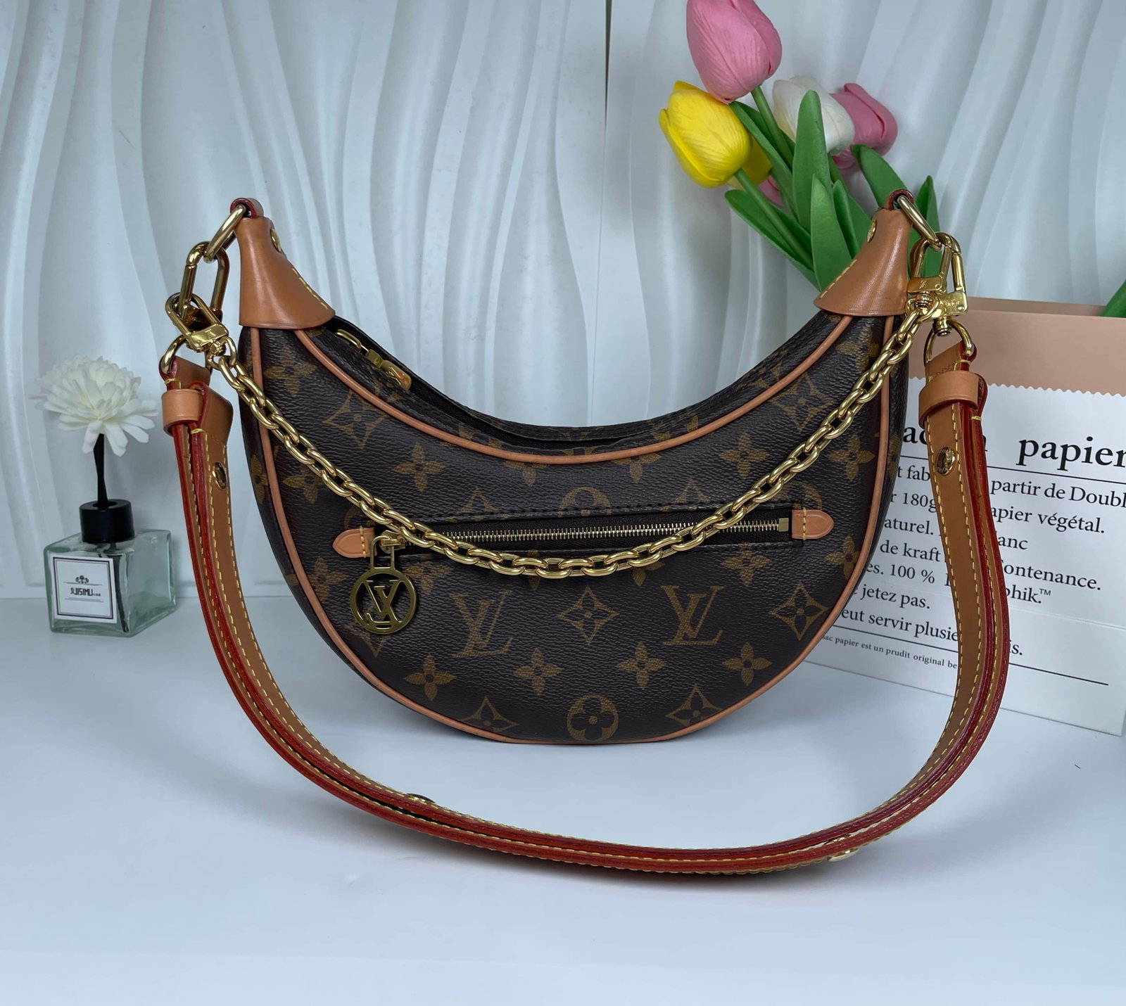 LOUIS VUITTON LOOP MONOGRAM CRESCENT BAG: LOUIS VUITTON LOOP MONOGRAM CRESCENT BAG LOUIS VUITTON, Loop. A crescent-shaped shoulder bag crafted from Monogram canvas with natural cowhide leather trim. Presented in very good condition, with the