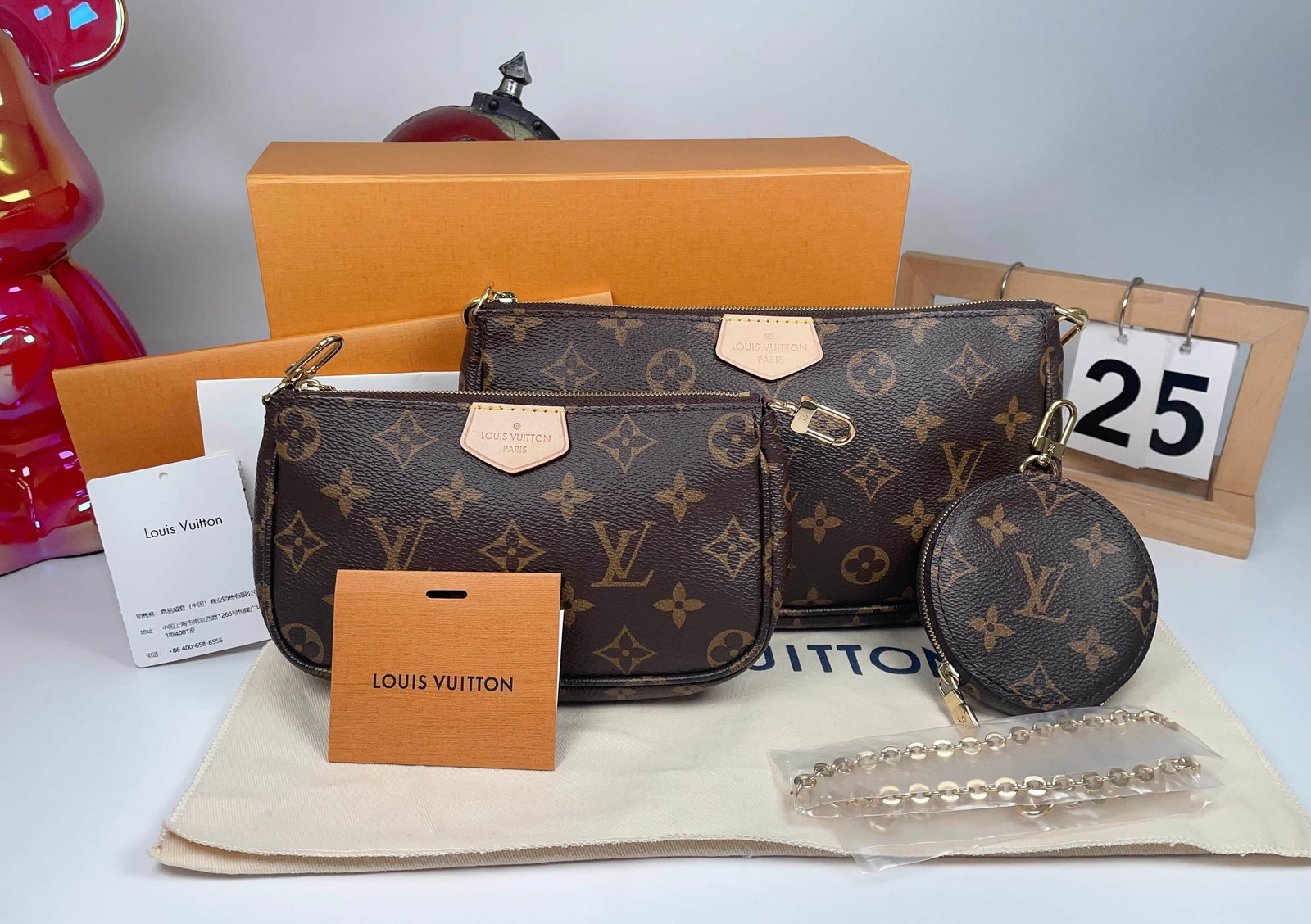 LOUIS VUITTON FIVE-PIECE MODULAR BAG SET: LOUIS VUITTON FIVE-PIECE MODULAR BAG SET LOUIS VUITTON. A five-piece modular pouch set with a green shoulder strap, dated 2025 and accompanied by a complete set of accessories and the original invoice