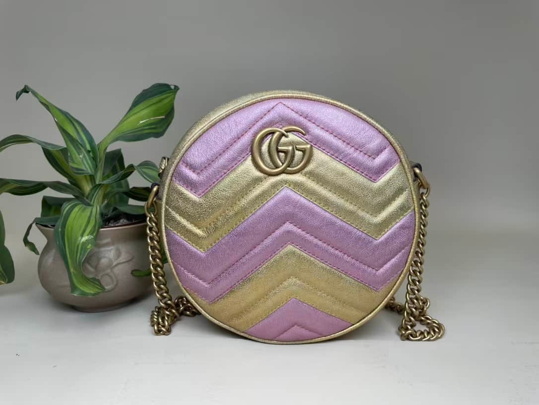 GUCCI GG MARMONT CIRCULAR SHOULDER BAG: GUCCI GG MARMONT CIRCULAR SHOULDER BAG GUCCI, GG Marmont. A circular bag crafted from pink leather with gold-tone hardware. Accompanied by the shoulder strap and accessories. Unused condition.