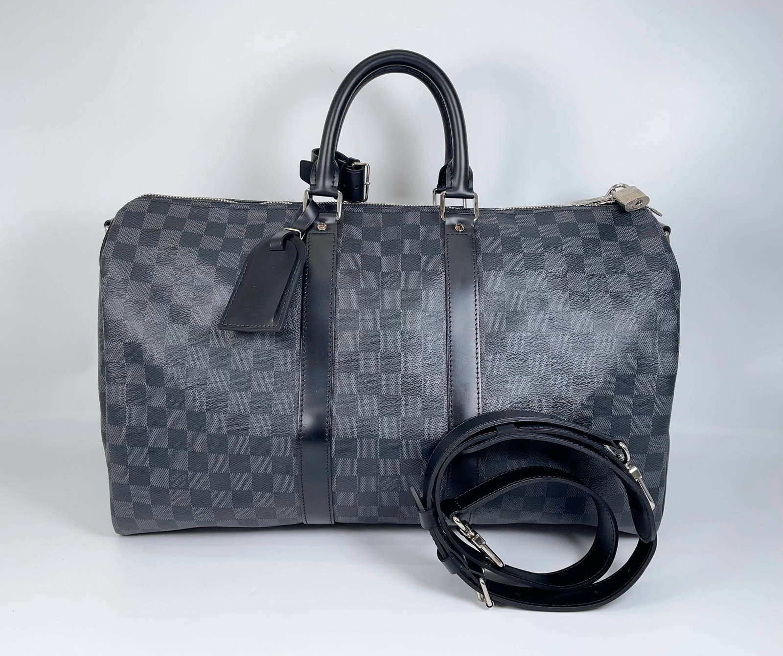 LOUIS VUITTON DAMIER GRAPHITE KEEPALL TRAVEL BAG: LOUIS VUITTON DAMIER GRAPHITE KEEPALL TRAVEL BAG LOUIS VUITTON, Keepall. A travel bag crafted from Damier Graphite coated canvas with polished leather trim. Featuring a zip closure, padlock fittings,