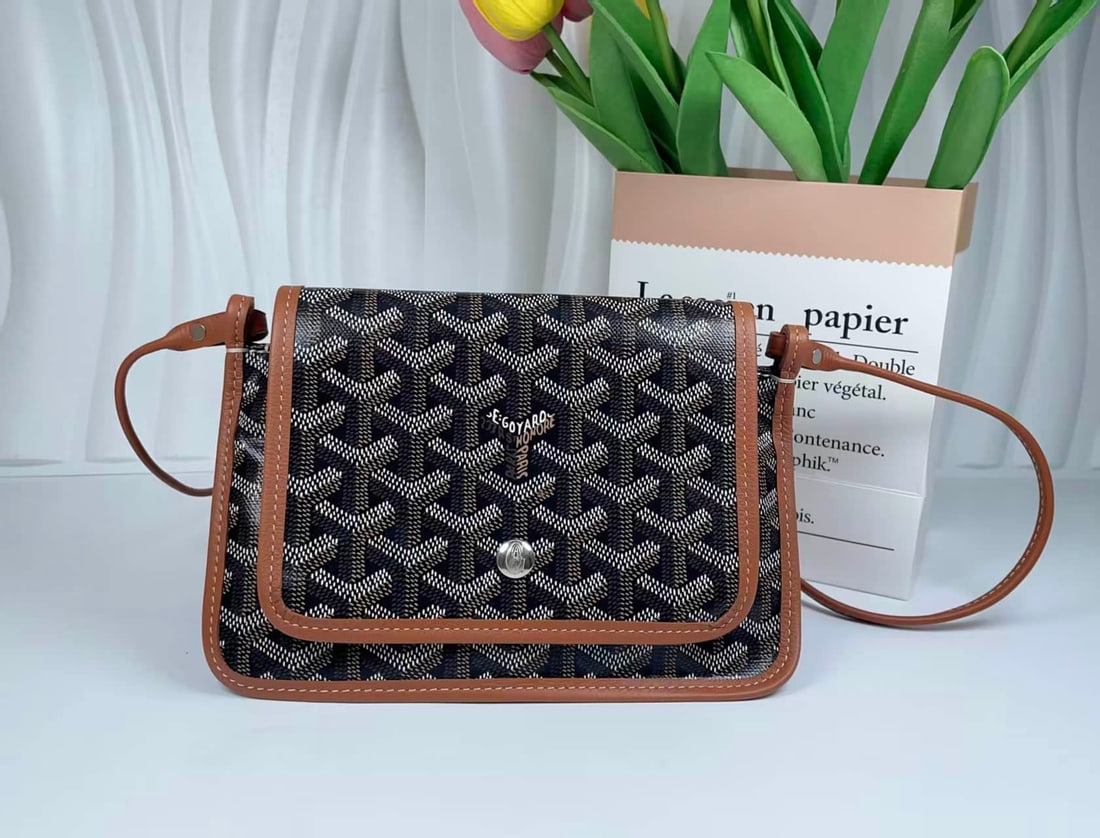 GOYARD PLUMET CROSSBODY WALLET: GOYARD PLUMET CROSSBODY WALLET GOYARD, Plumet. A crossbody wallet crafted from signature Goyardine coated canvas with calfskin trim. Featuring a snap-fastened flap, detachable shoulder strap and
