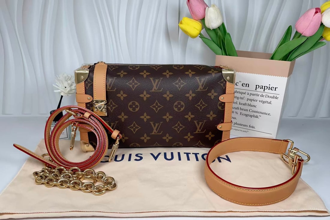 LOUIS VUITTON SIDE TRUNK EAST WEST BAG: LOUIS VUITTON SIDE TRUNK EAST WEST BAG LOUIS VUITTON, Side Trunk East West. A Monogram canvas shoulder bag with natural cowhide leather trim and multiple detachable straps, allowing several carrying c