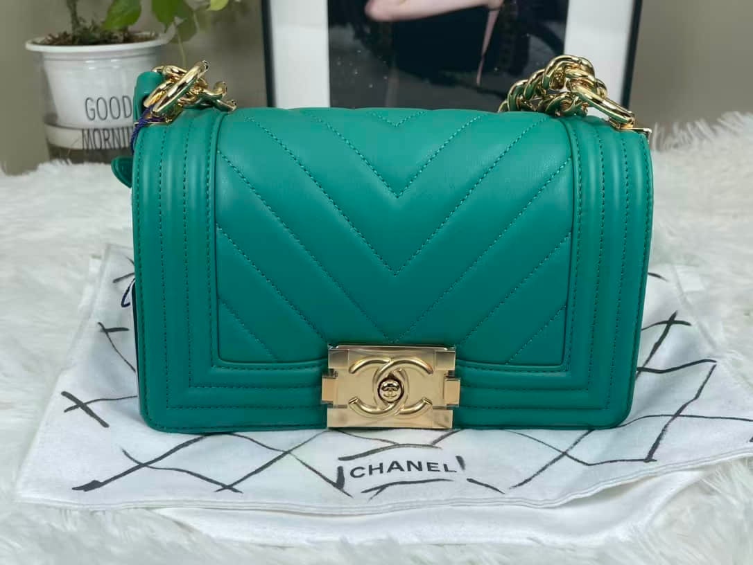 CHANEL BOY SMALL CHEVRON CALFSKIN SHOULDER BAG: CHANEL BOY SMALL CHEVRON CALFSKIN SHOULDER BAG CHANEL, Boy, Small. An emerald-green calfskin shoulder bag with chevron quilting and gold-tone hardware, bearing a 27-series serial number. Dimensions: