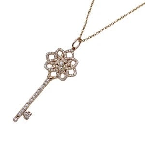 DIAMOND-SET KEY PENDANT NECKLACE WITH FLORAL OPENWORK DESIGN (20TH CENTURY): DIAMOND-SET KEY PENDANT NECKLACE WITH FLORAL OPENWORK DESIGN (20TH CENTURY) Provenance and Authenticity: This elegant pendant necklace features a finely crafted key motif enhanced with pavé-set
