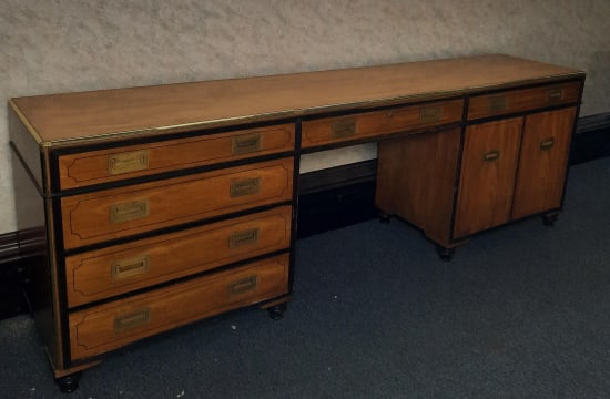 Baker Furniture Collectors Edition Desk PROVENANCE: Private: PROVENANCE: Private estate MATERIAL: Wood & brass DIMENSIONS: 30"t x 90"L x 19"w CONDITION: Loose handle of drawer missing screw dents on top. Crack in one handle, no key