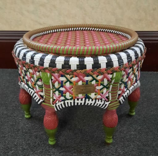 Mackenzie Childs Breezy Poppy Outdoor Ottoman PROVENANCE: Private: PROVENANCE: Private estate MAKER: Mackenzie Childs MATERIAL: Resin Wicker DIMENSIONS: 16" tall & 24" diameter