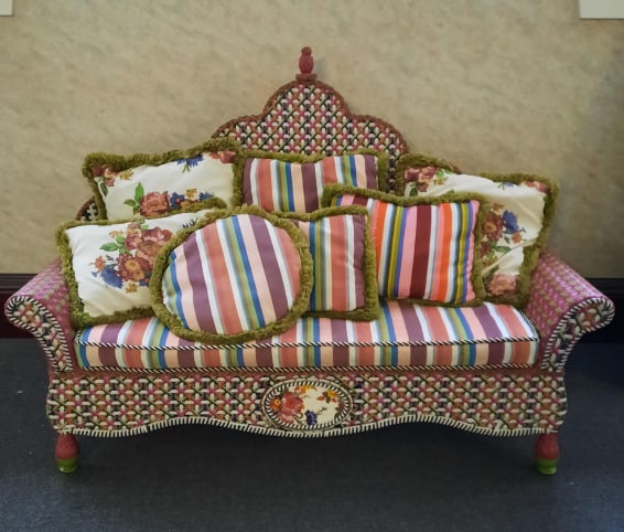 Mackenzie Childs Breezy Poppy Outdoor Love Seat PROVENANCE: Private: PROVENANCE: Private estate MAKER: Mackenzie Childs MATERIAL: Resin Wicker DIMENSIONS: 50" tall, 72" long and 27" deep CONDITION: Cushions need to be cleaned