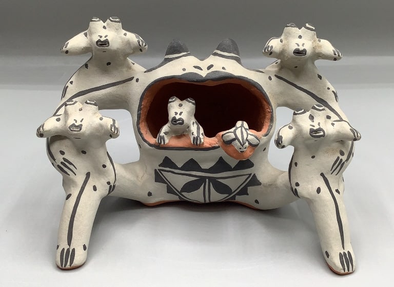 Frog Storyteller by Martha Arquero Born in 1944 into the Cochiti Pueblo. She has been making pottery: Born in 1944 into the Cochiti Pueblo. She has been making pottery since the late 1960s. Martha is the Museum of Indian Arts & Culture 2024 Legacy Award recipient. She uses natural pigments to hand coi