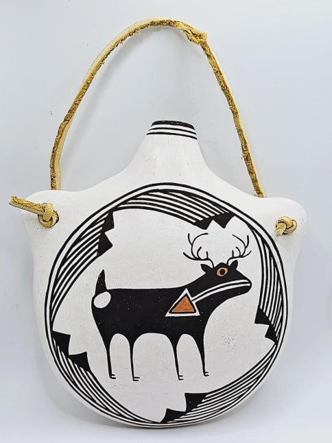 Acoma Pottery Canteen Signed Dolores Lewis Also known as Delores Lewis Garcia, Road Runner Clan, was: Also known as Delores Lewis Garcia, Road Runner Clan, was active in pottery making from 1953-1998. She is the daughter of Lucy M. Lewis, one of the respected matriarchs of Acoma potters. She praised h