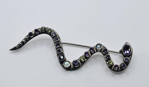 Nicky Butler Sterling Silver Multi Gem Snake Pin Maker: Nicky: Maker: Nicky Butler Metal: Sterling Silver Size: 3.5" Main Gemstones: Peridot, Topaz, Moonstone & Amethyst Weight: 13.0 TGW