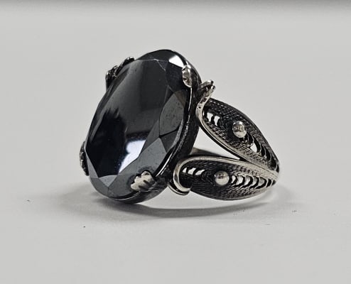 Sterling Silver Hematite Filigree Ring Ring weighs 5.9: Ring weighs 5.9 Grams Size 7 Hematite is a mineral that is a deep brownish-red in color, but when it's carved and polished, it takes on a glossy black or deep silver-grey hue.