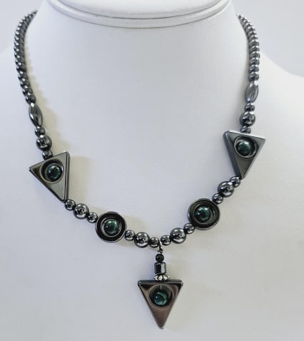 Hematite Malachite Arrow Necklace Necklace weighs 33.8: Necklace weighs 33.8 Grams Measures 18" This is a necklace made of hematite beads in various shapes and sizes. It features small round beads interspersed with larger round beads, each of which has a s