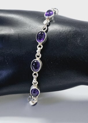 Sterling Silver Amethyst Bracelet Bracelet weighs 10.9: Bracelet weighs 10.9 Grams This is a delicate sterling silver bracelet featuring oval-shaped amethyst gemstones in a bezel setting. The stones are evenly spaced along the bracelet, connected by small 