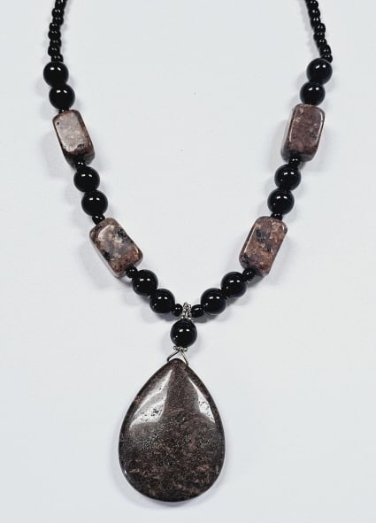 Black Onyx & Jasper Necklace Necklace measures: Necklace measures 20" Clasp is silver tone This necklace features a striking combination of black onyx and reddish-brown jasper beads. The black onyx beads are round and polished, providing a sleek co