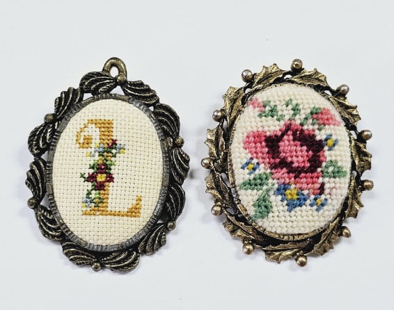 Vintage Needlepoint Necklace Pendants Two vintage brooches featuring oval frames with ornate edges. (1 of 3)