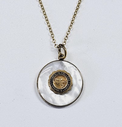 12K Gold Filled Oberlin College Necklace Necklace is 18": Necklace is 18" long. This is a delicate gold filled necklace with a circular mother-of-pearl pendant. The pendant features a gold bezel surrounding a black enamel center with gold lettering that read