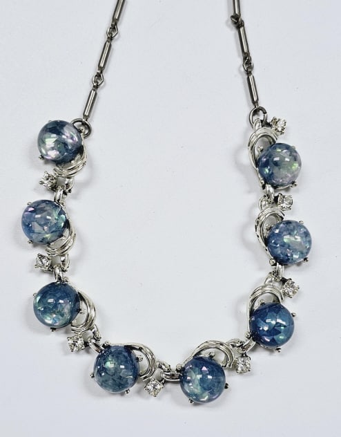 Vintage Coro Blue Lucite & Rhinestone Necklace Necklace measures: Necklace measures 16" This is a vintage necklace with large blue cabochon lucite beads set in silver-tone metal. The stones are surrounded by small clear rhinestones.