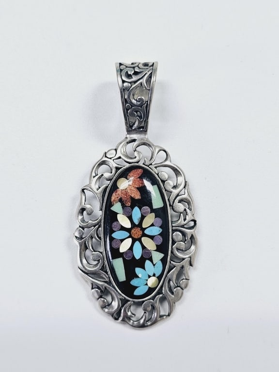 Carolyn Pollack Sterling Inlay Gemstone Pendant Pendant weighs 14.7: Pendant weighs 14.7 Grams The pendant contains the following gemstones: Black Onyx, Turquoise, Mother of Pearl, and Spiny Oyster.