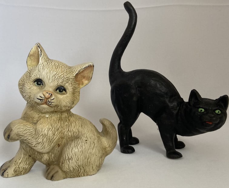 Cast Iron Cat Doorstops Set of Two Two cat doorstops, one white and one black. Both are unmarked.: Two cat doorstops, one white and one black. Both are unmarked. White cat is 7 1/2 inches tall. Black cat is 10 1/4 inches tall to the tip of the tail.