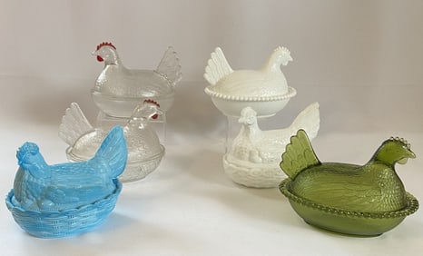 Glass Hens On A Nest Set of Six Six glass chicken in baskets, two milk glass, two clear, one green,
