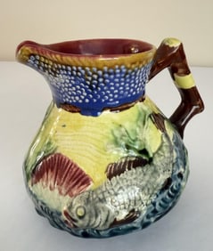 Majolica Pitcher Fish Motif Approximately 5.5 inches tall. Some crazing present. Glaze missing from