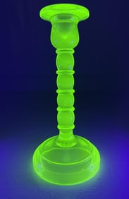 Uranium Glass Candlestick Approximately 8 inches tall. No cracks or chips.