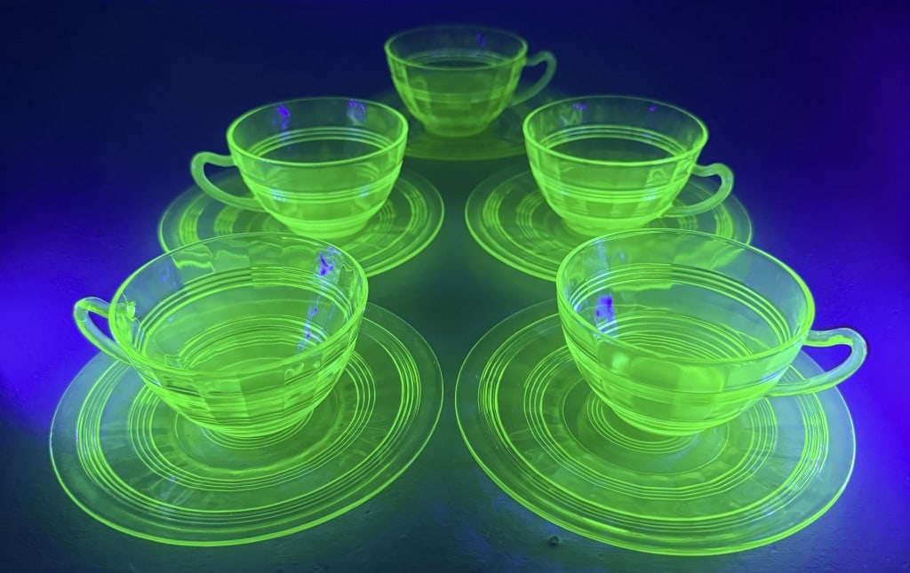 Uranium Glass Cup and Saucer Lot 5 sets plus 4 extra saucers One small chip in one cup otherwise (1 of 4)