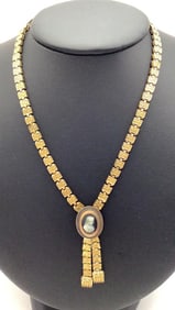 Victorian Engraved Book Chain Cameo Necklace Necklace  is gold tone. Necklace is 17"