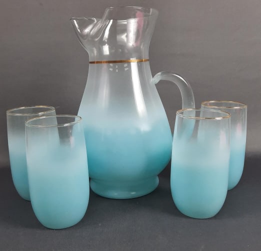Vintage Blue Blendo Pitcher & 4 Glasses Set Some gold worn off around the rims of the cups. Some: Some gold worn off around the rims of the cups. Some small scratches present. Please see images for details regarding the condition. Pitcher 10 inches tall. Glasses measure 5 inches tall.