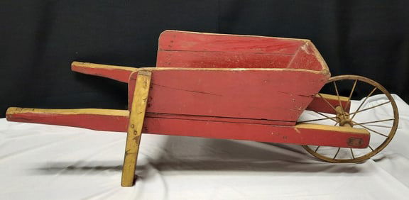 Small Vintage Wooden Wheelbarrow Measures 36 x 15 x 12 inches tall. Cracks, scratches and marks.