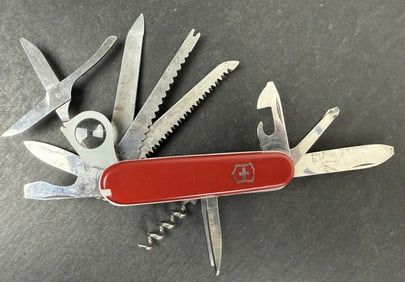 Victorinox Swiss Army Knife With leather case 5.5 x 2 x 2 inches. Missing tweezers. Large knife