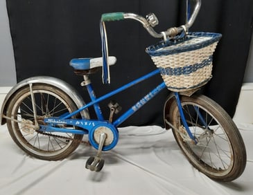 Vintage Blue Schwinn Pixie Children’s Bicycle Tires are flat. Rust and dirt present. Tear in the
