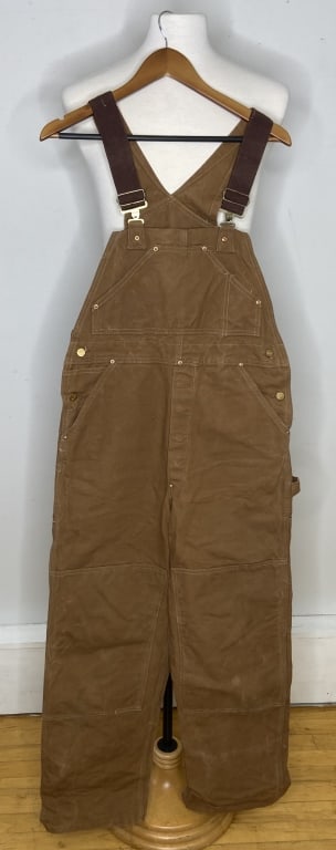Vintage Carhartt Bib Overalls Tan colored bib overalls by Carhartt. Clean, one small hole on back of: Tan colored bib overalls by Carhartt. Clean, one small hole on back of left leg. Measurements lying flat are: Length shoulder to hem: 58 inches Waist 17 1/2 inches Leg width: 12 inches Hips: 19 1/2 in
