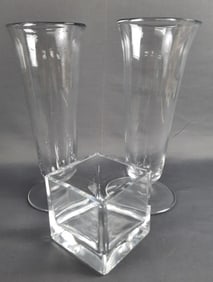 Three Clear Glass Vases Vases are 11 inches tall. Square vase is 4 x 4 x 4 inches. Please see images