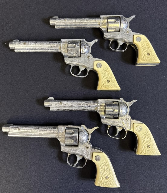 Vintage 1950s Nichols Stallion 38 Cap Gun Lot Some corrosion present. Many used cartridges included: Some corrosion present. Many used cartridges included 2 have working mechanisms, 2 are not. Approximately 12 x 5 inches.