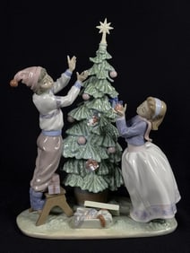 Lladro Porcelain Figurine 5897 Trimming The Tree Approximately 11 inches wide by 12 inches tall.
